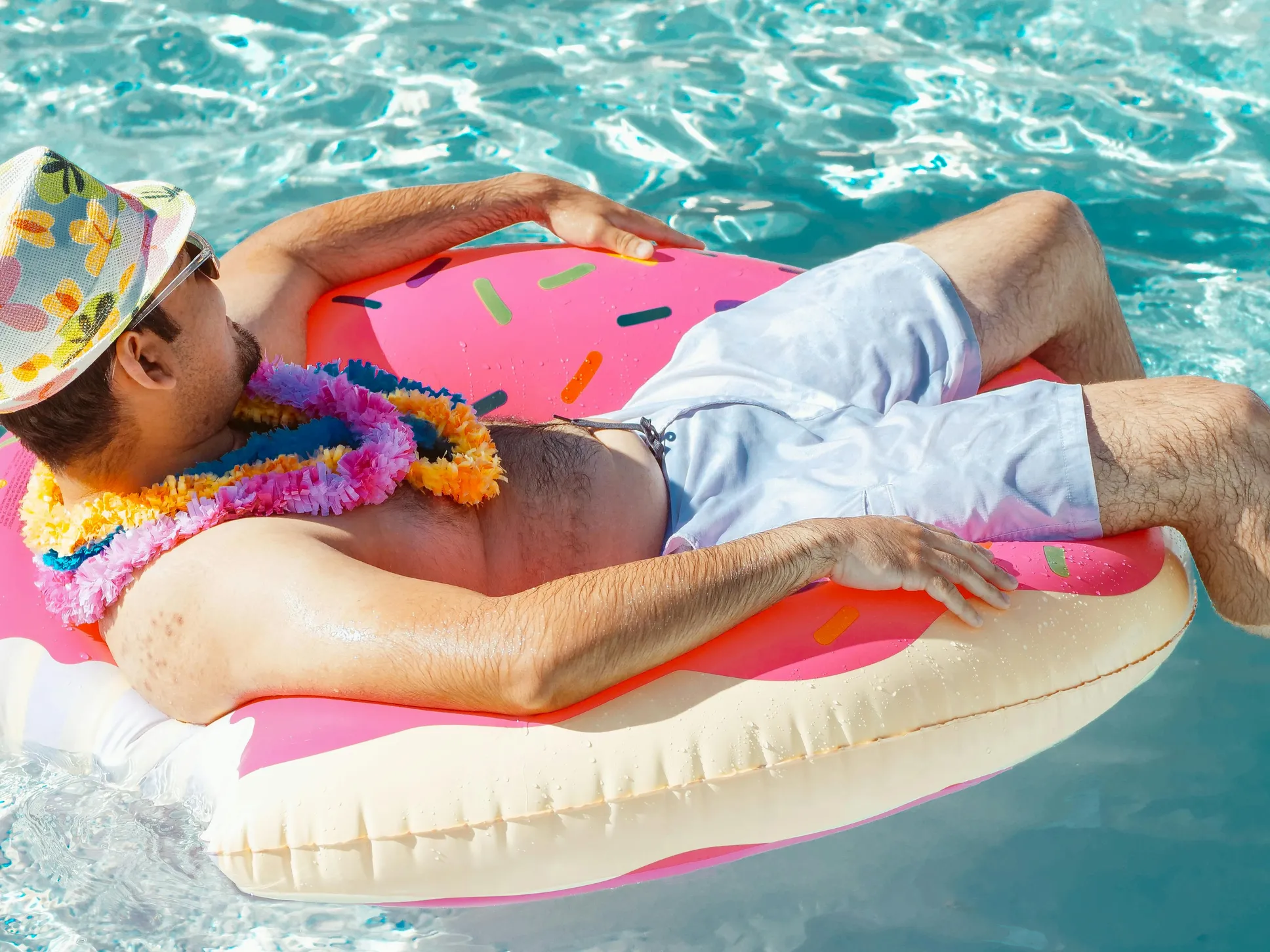 Man relaxing in a pool float, representing leisure costs in Arizona pool cost calculator.