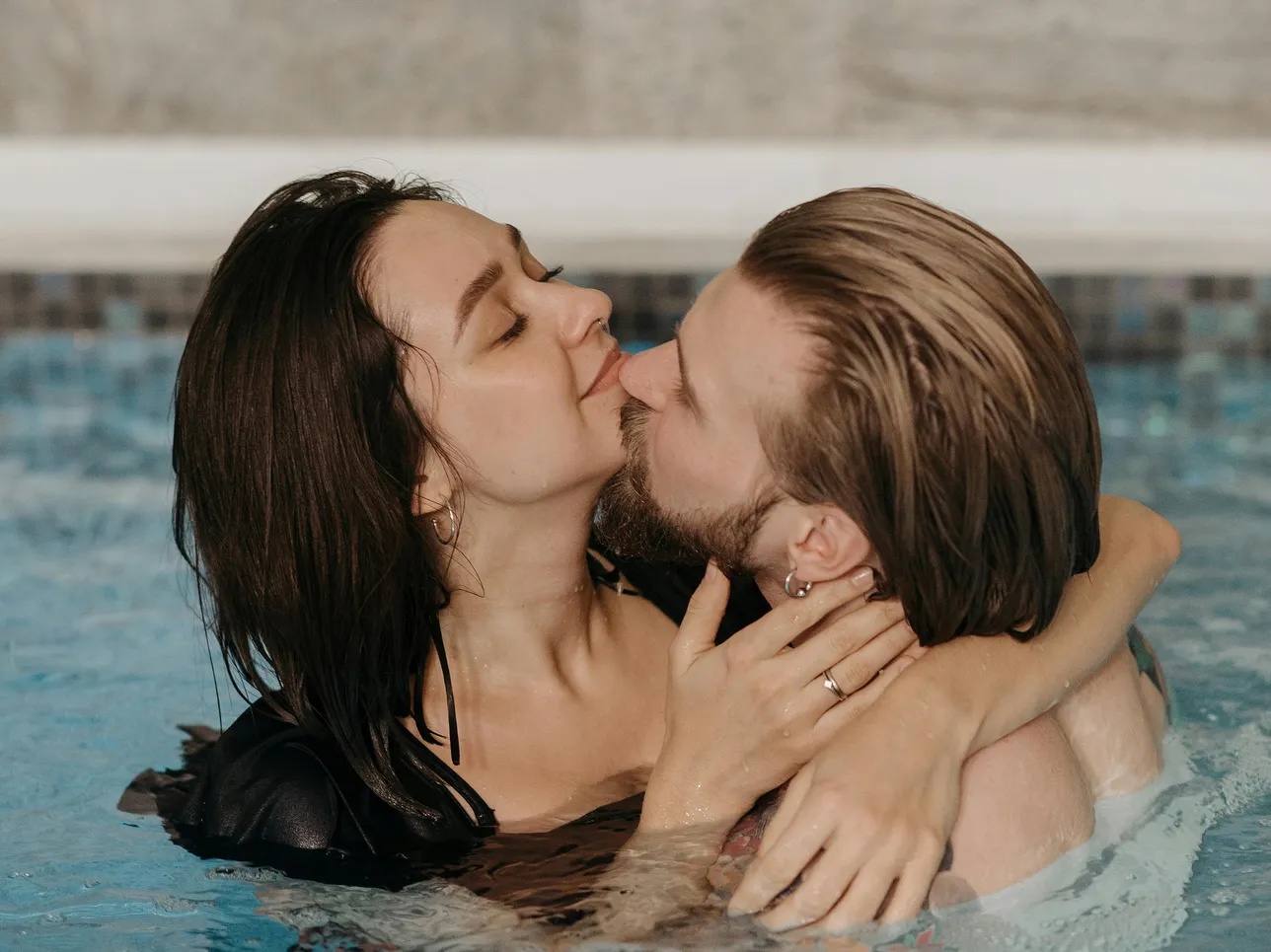 Couple in a pool demonstrating the importance of corrosion protection in aquatic environments.