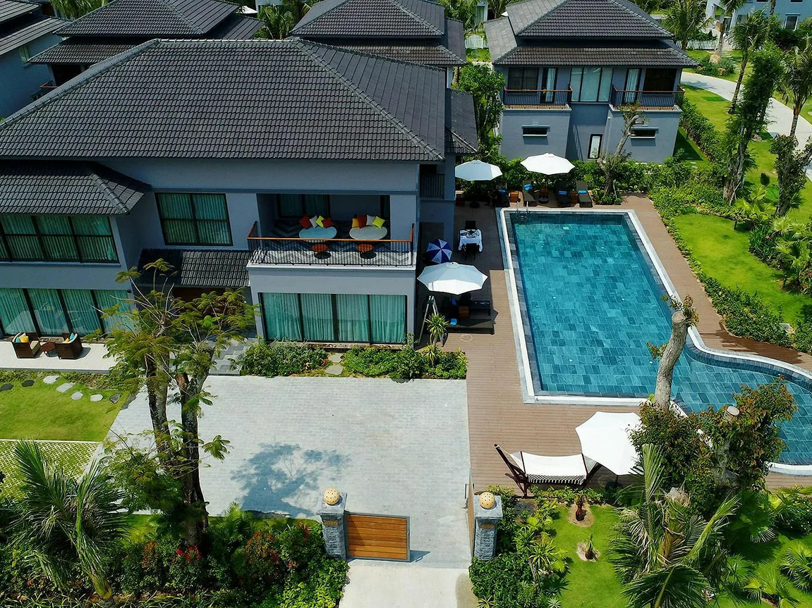 A luxurious cruise ship pool surrounded by tropical gardens and lounging areas, ideal for relaxation and leisure.