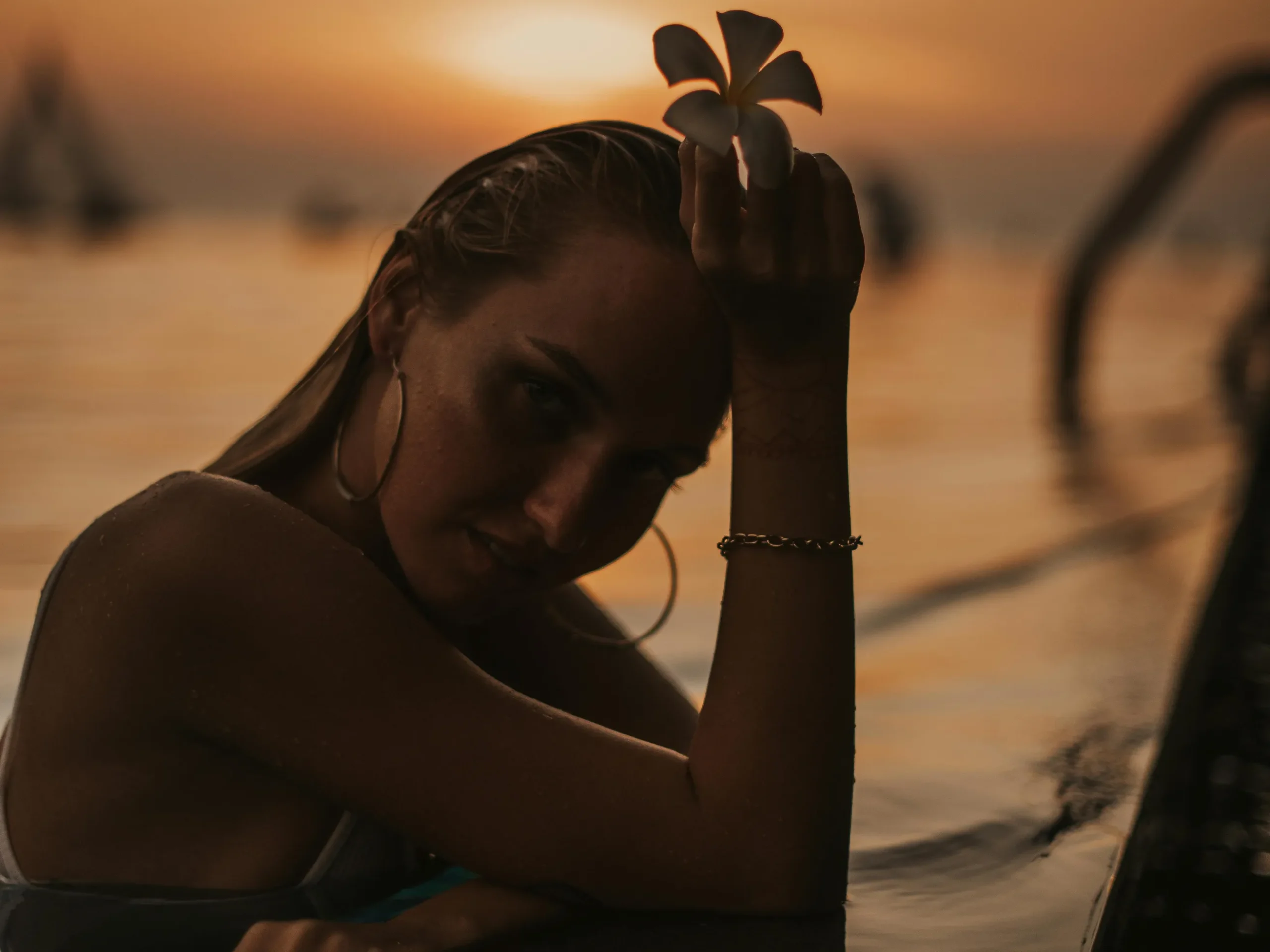 Woman relaxing in a pool at sunset, relevant to filling the pool after plaster.