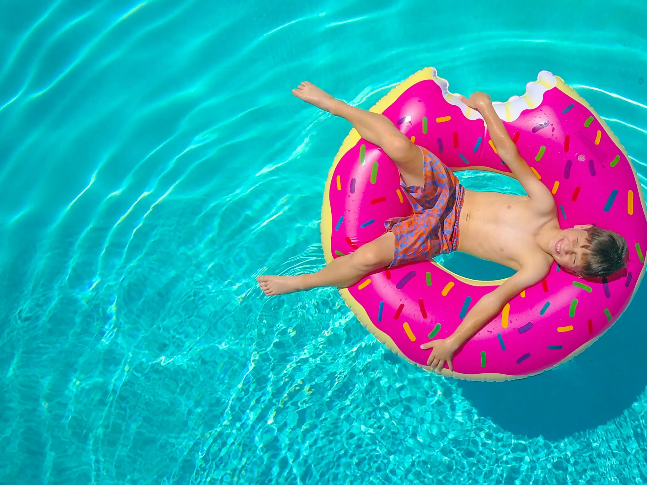 Child Floating In Indoor Pool During Thunderstorm