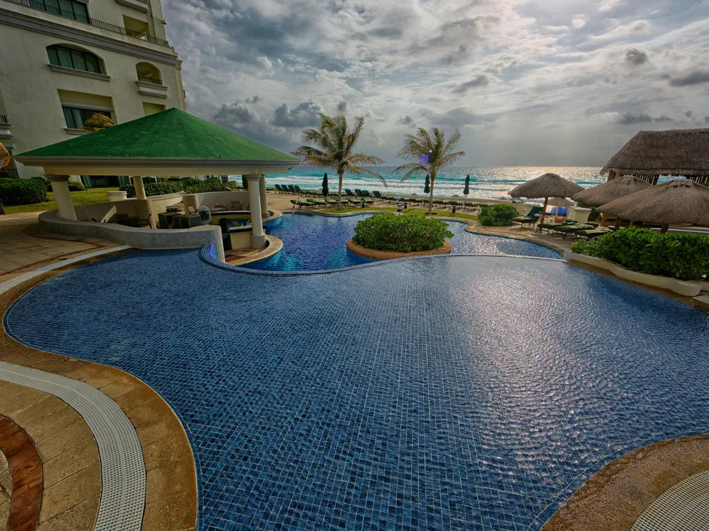 A beautiful poolside resort showing a blue pool, perfect for discussing Klean Strip Muriatic Acid usage.