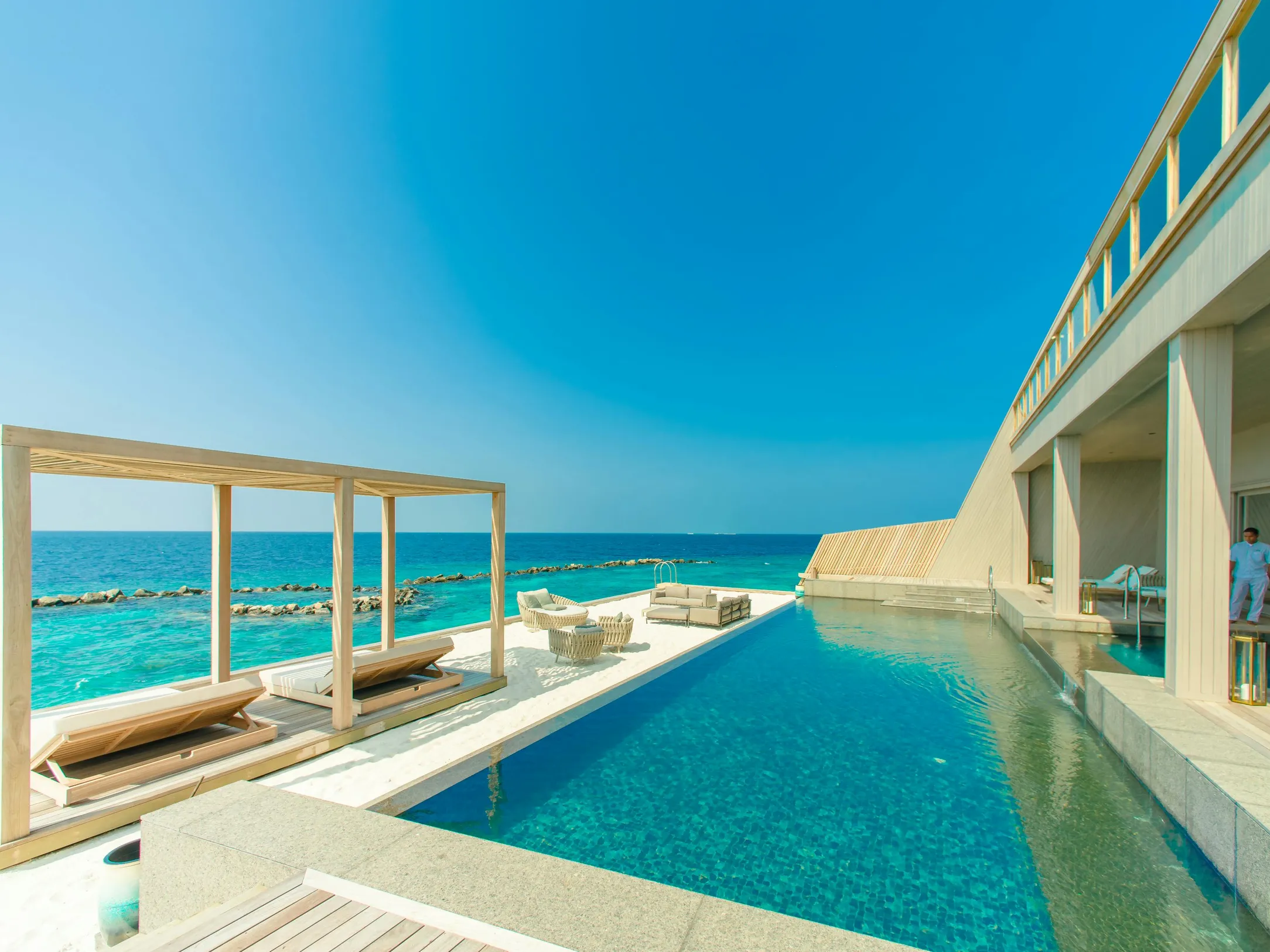 A serene swimming pool by the ocean, exploring if pool chlorine is safe for hot tubs and inflatable pools.