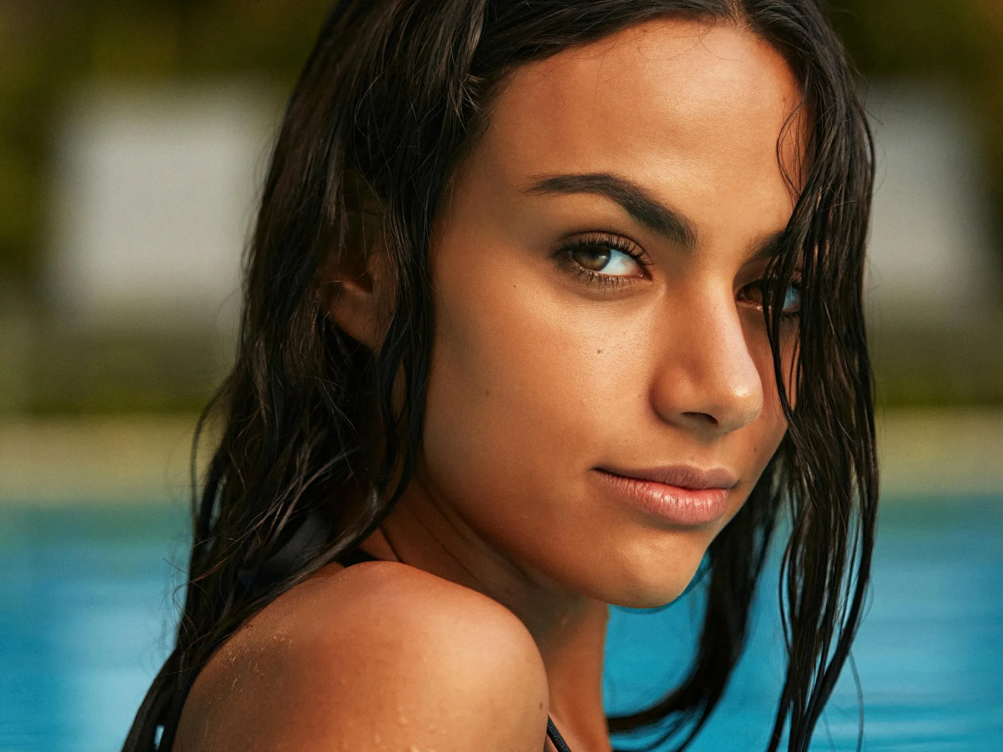 A person relaxing near a pool, emphasizing the importance of preparing your pool for closing.