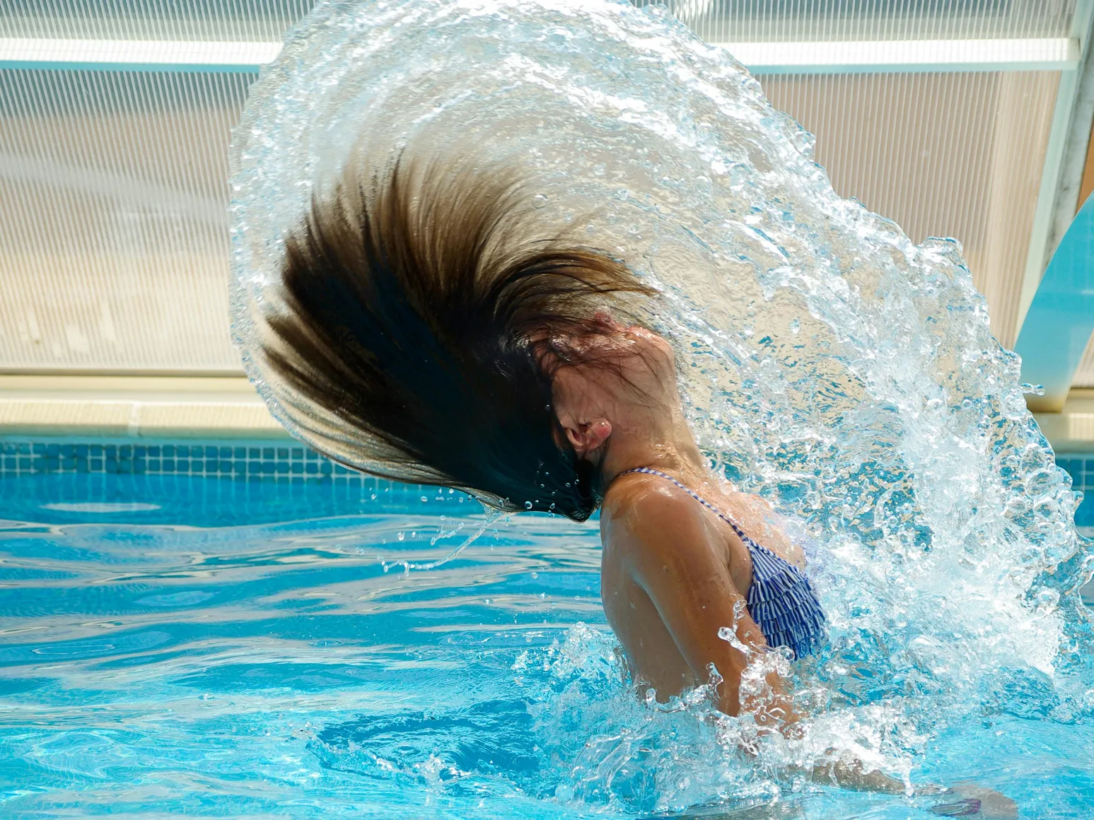 A woman enjoying a swim, highlighting the importance of clean water with a pool filter cartridge.