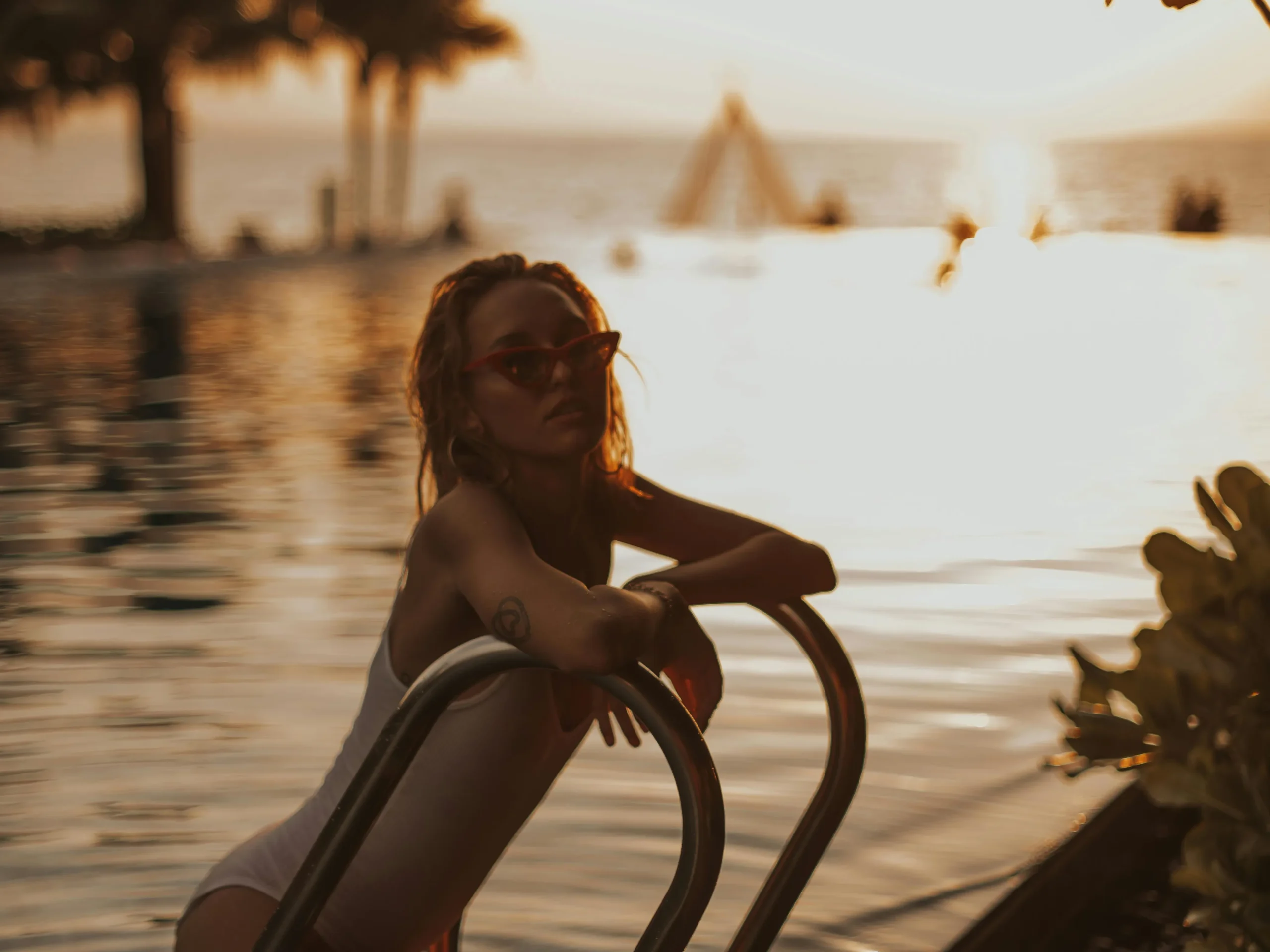 A woman relaxing by the pool, illustrating pool maintenance in a serene environment.