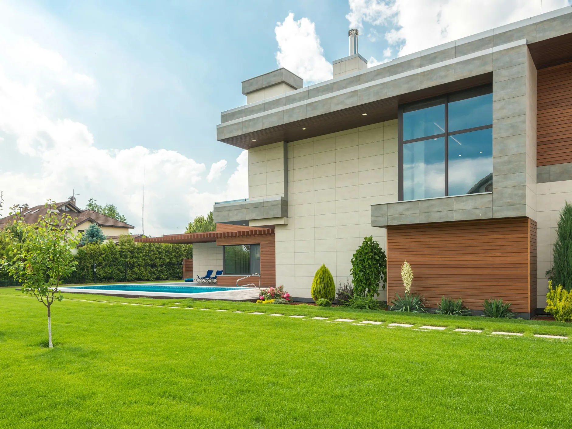 A modern poolside view showcasing a residential area, relevant to the effects of pH levels on algae growth.