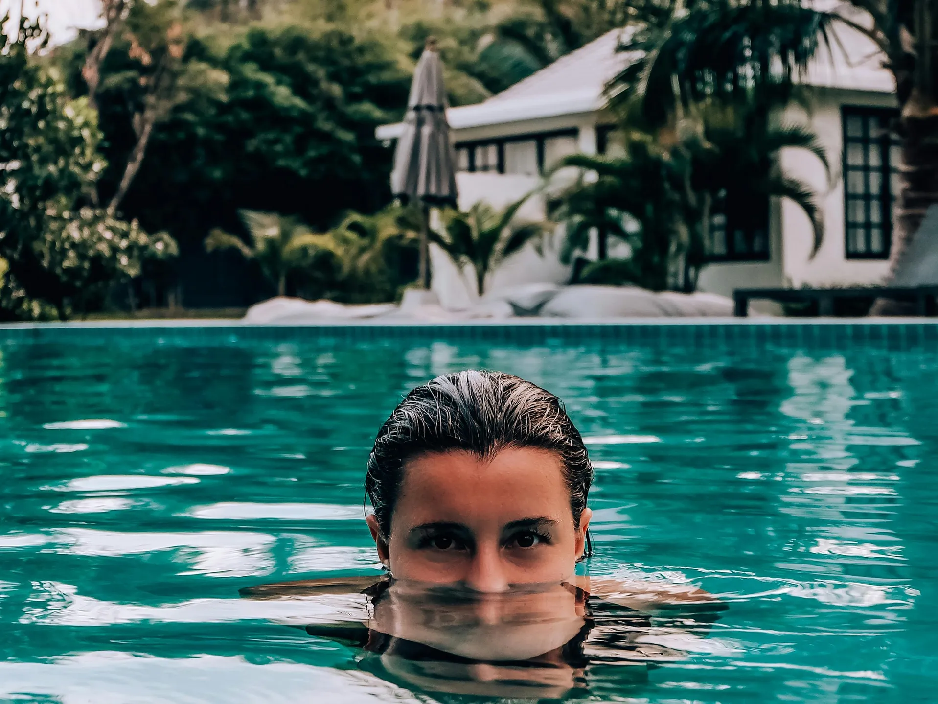 A person in a pool where the liner could potentially be power washed, illustrating the concept.