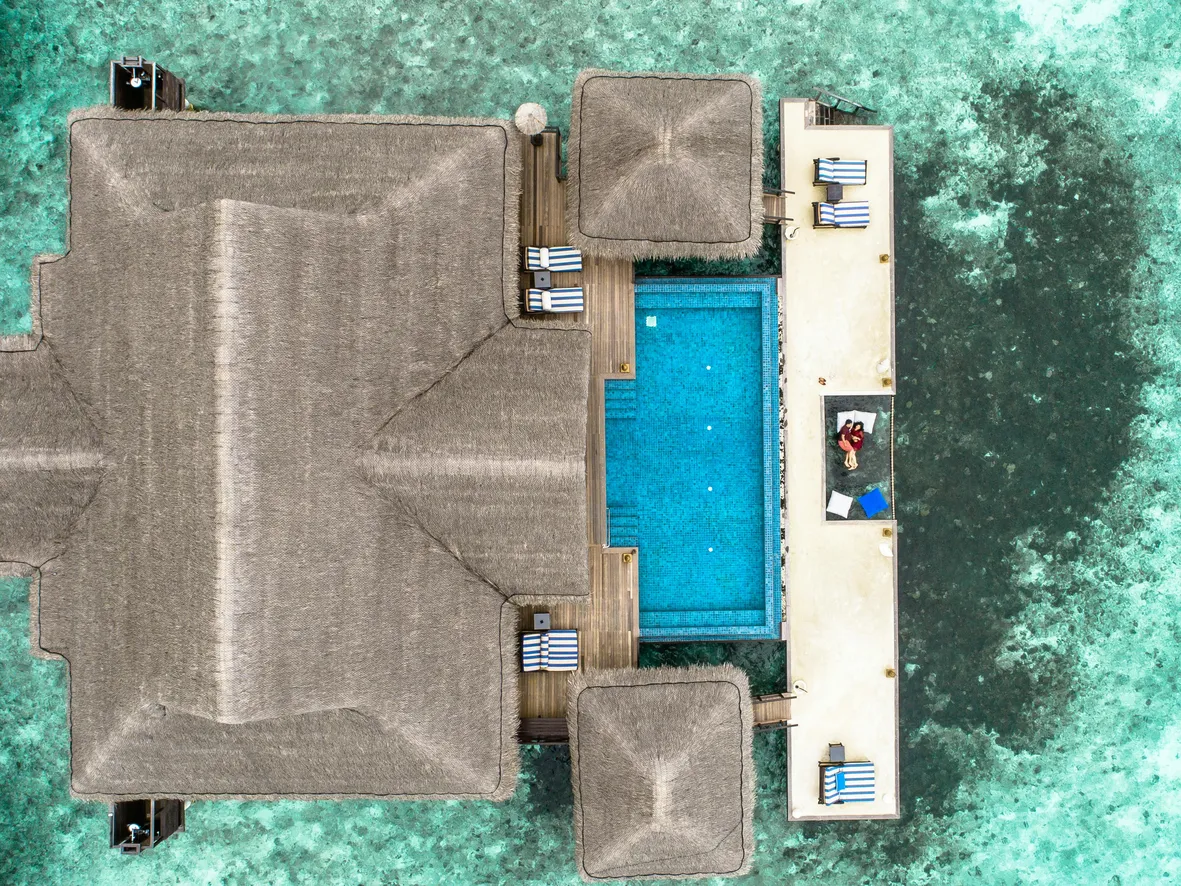 Aerial view of a serene pool area, perfect for relaxation and recreational activities after returning to the pool.