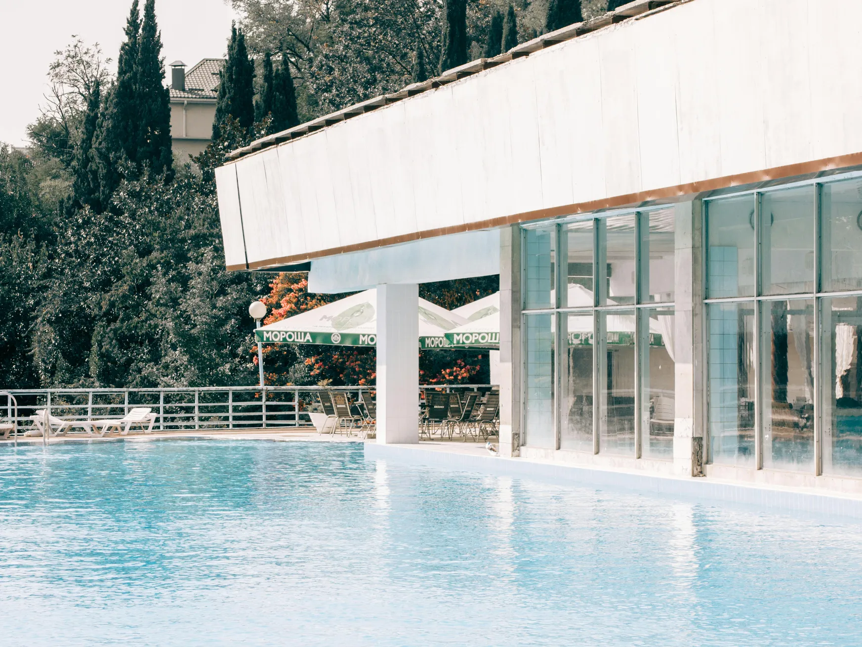A beautiful swimming pool with solar heating systems visible, showcasing potential costs for solar heaters.