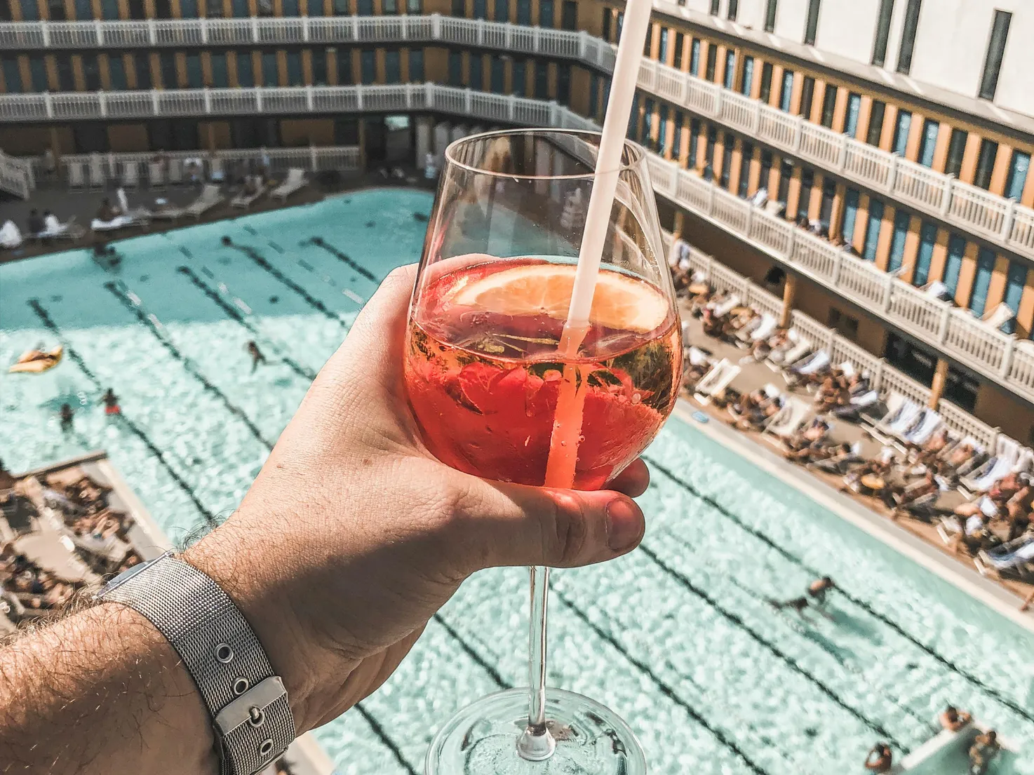 A refreshing drink by the pool, illustrating the comfort of using solar pool ionizers