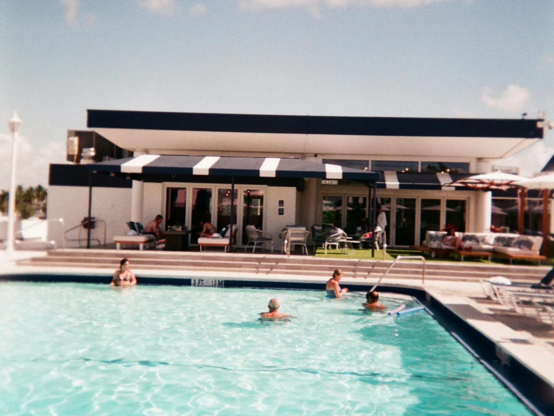 People swimming in a pool illustrating the question Do You Sweat In A Pool.